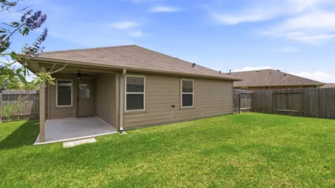 a view of a house with a backyard