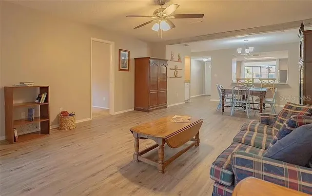 a view of a bench in a garden with lawn chairs