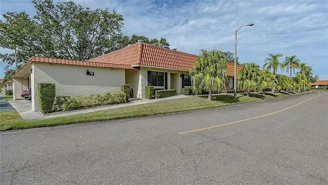 a front view of a house with a garden