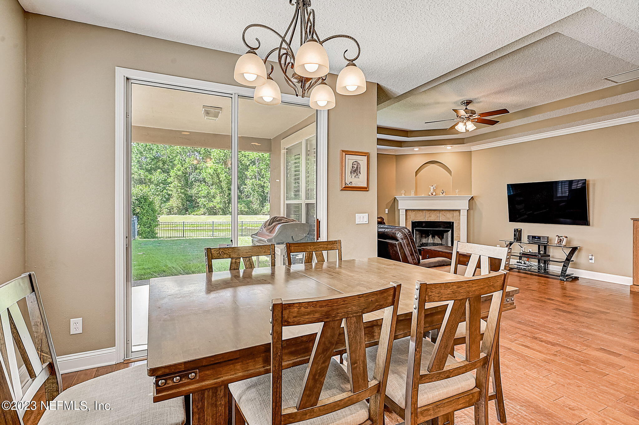 1828 Rear Admiral Lane St. Johns, FL 32259 - Photo 14 of 48 a dining room with wooden floor a chandelier a wooden table and chairs