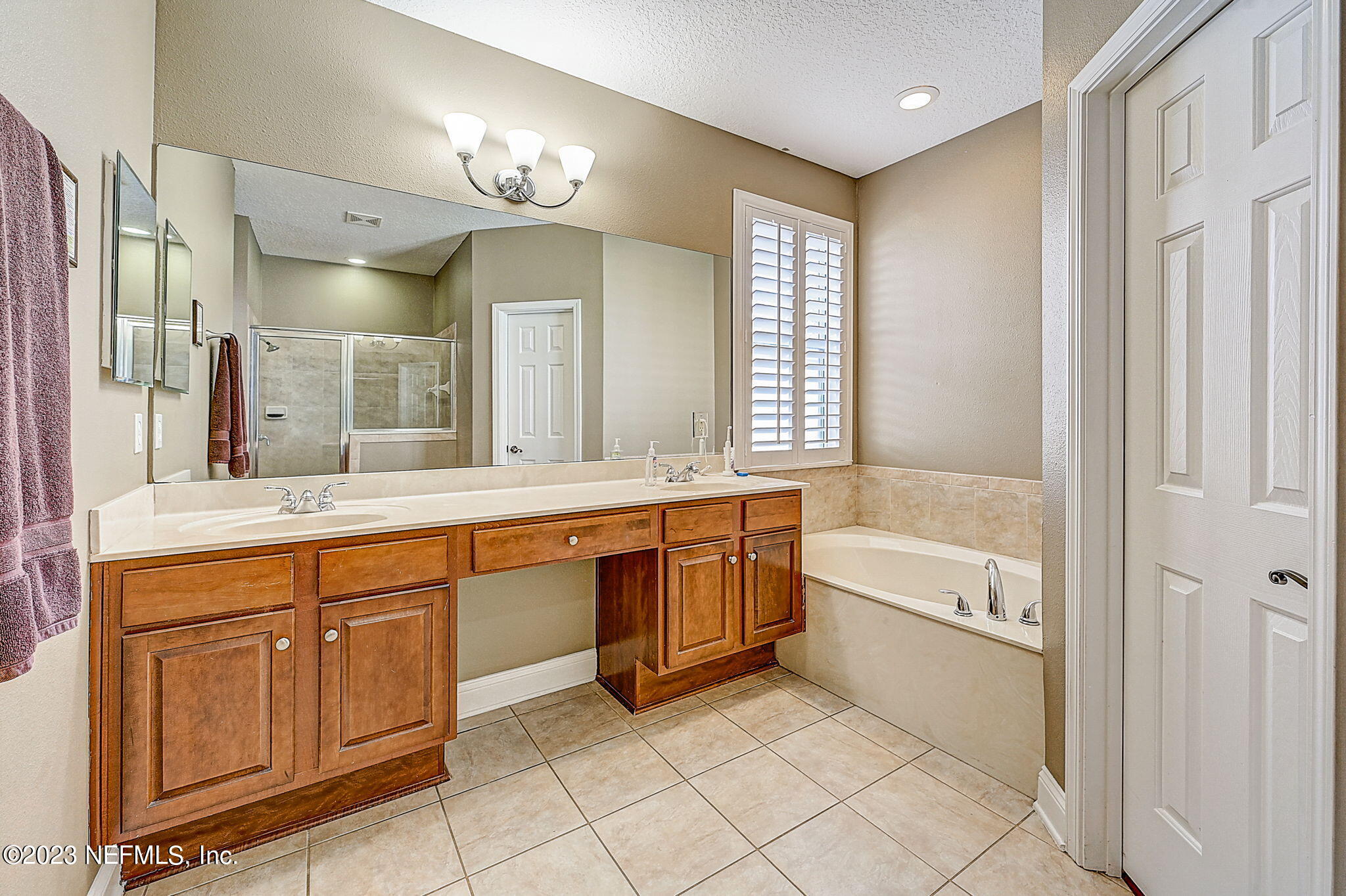 1828 Rear Admiral Lane St. Johns, FL 32259 - Photo 21 of 48 a spacious bathroom with a granite countertop tub sink shower and mirror