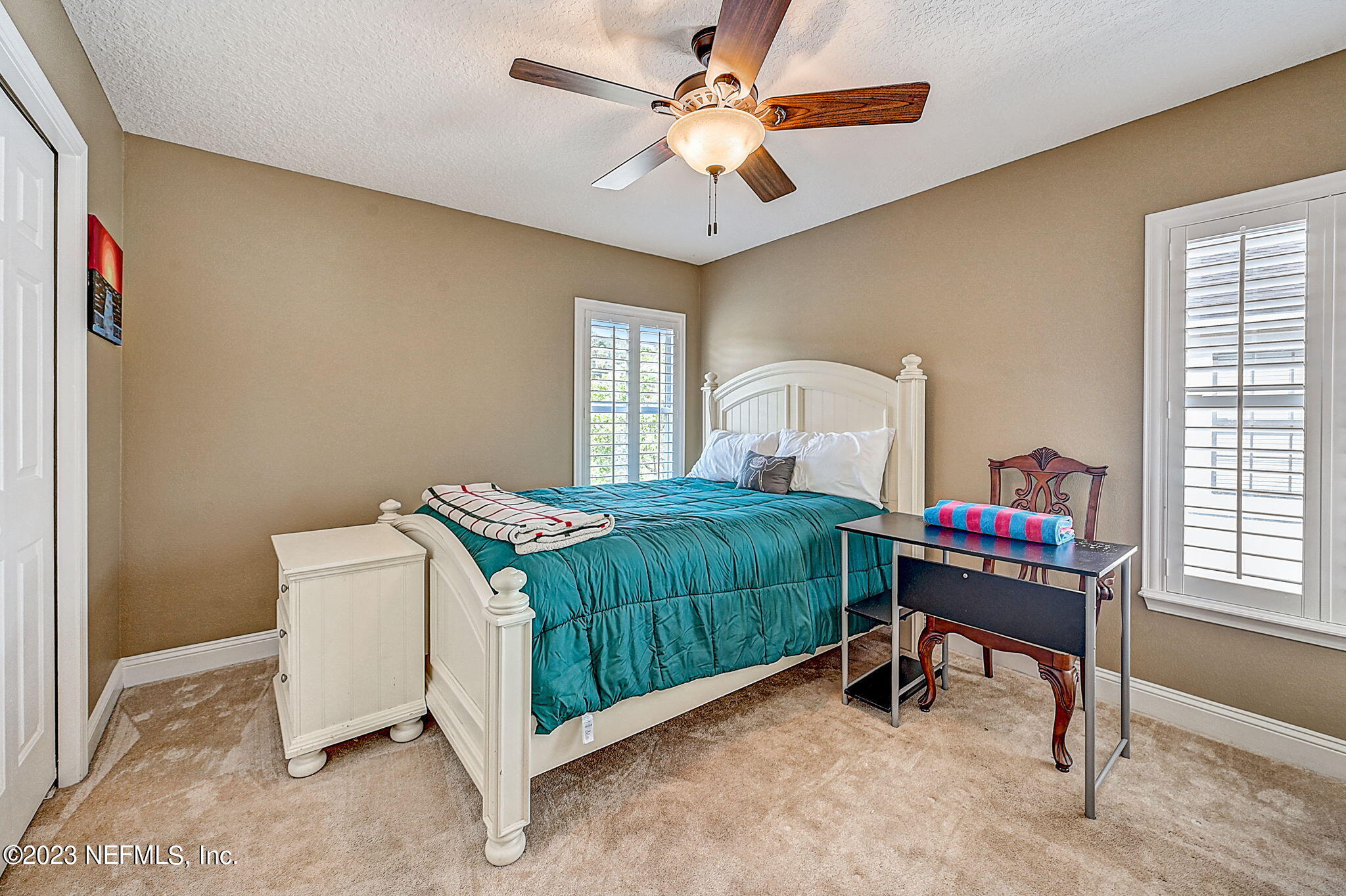1828 Rear Admiral Lane St. Johns, FL 32259 - Photo 27 of 48 a bedroom with a bed and a chandelier