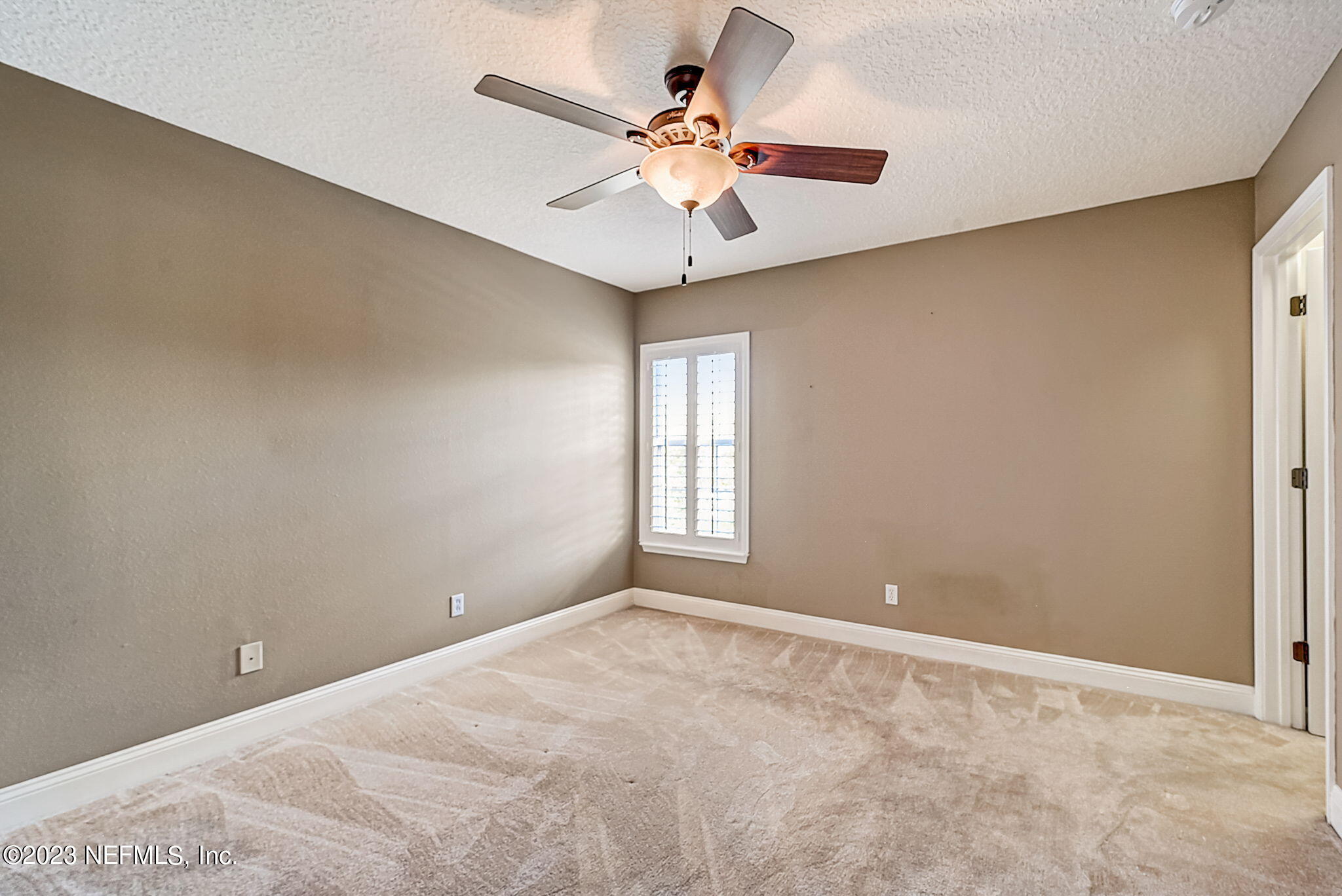 1828 Rear Admiral Lane St. Johns, FL 32259 - Photo 29 of 48 an empty room with a chandelier fan and windows