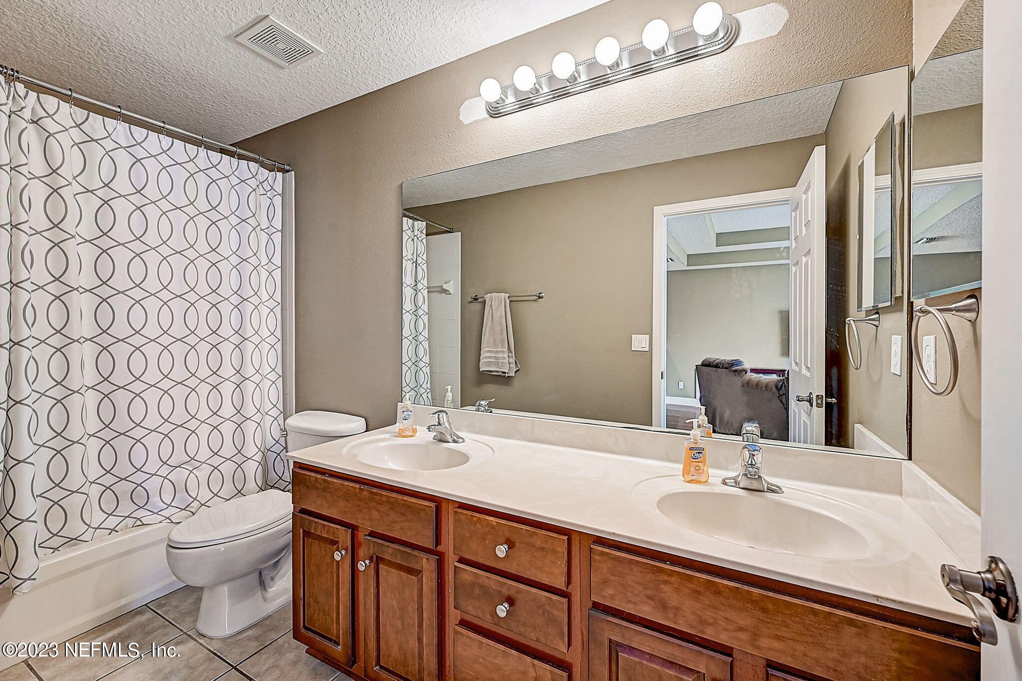 1828 Rear Admiral Lane St. Johns, FL 32259 - Photo 31 of 48 a bathroom with a double vanity sink toilet and a mirror