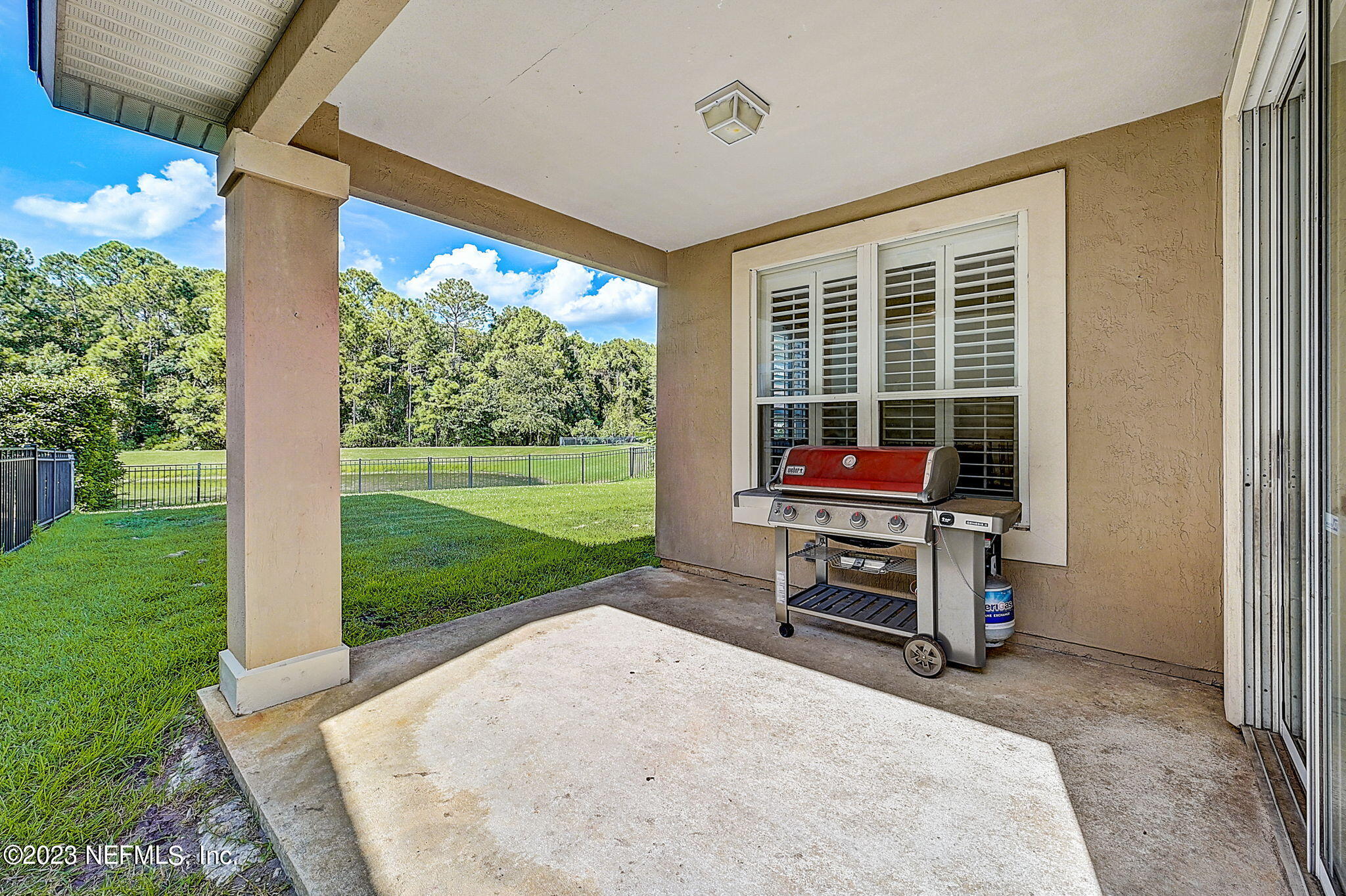 1828 Rear Admiral Lane St. Johns, FL 32259 - Photo 36 of 48 a backyard of a house with barbeque oven outdoor seating and garden