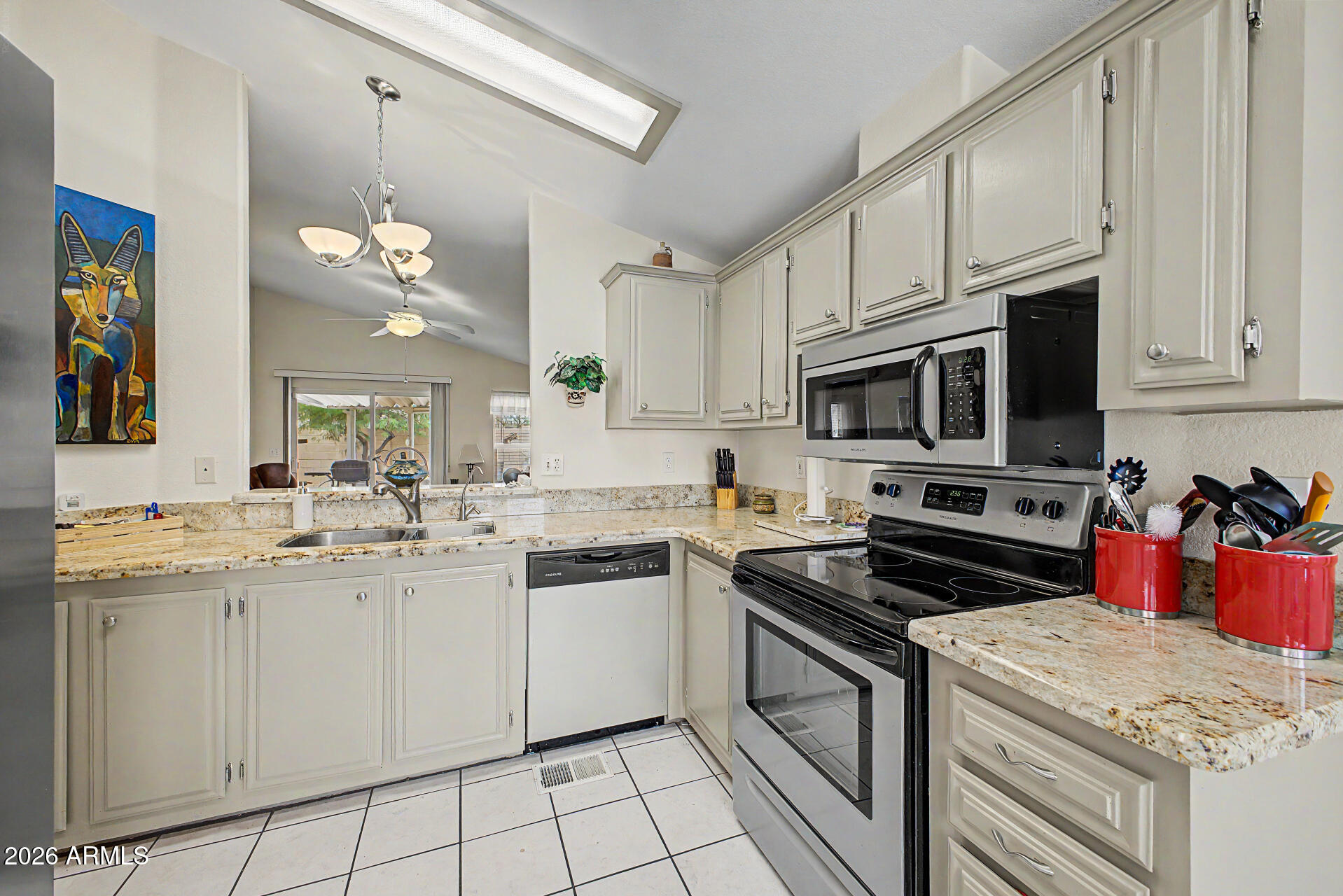 2101 South Meridian Road, Unit 45 Apache Junction, AZ 85120 - Photo 10 of 36 a kitchen with a sink stove top oven and cabinets
