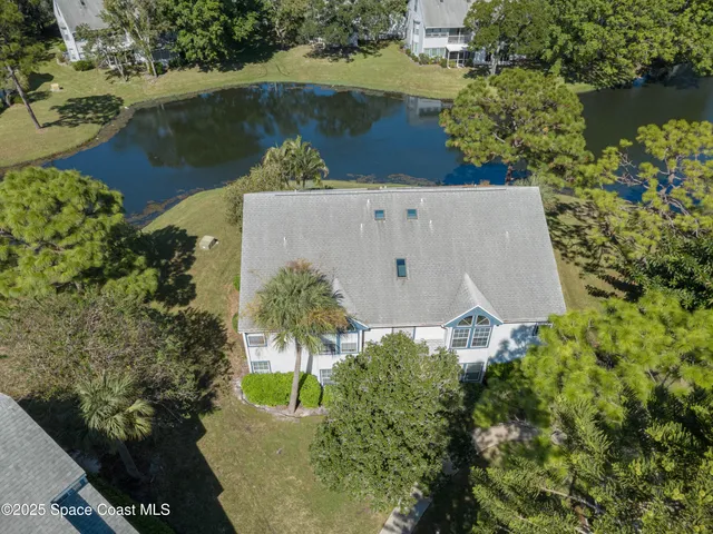 an aerial view of a house a yard and a lake view