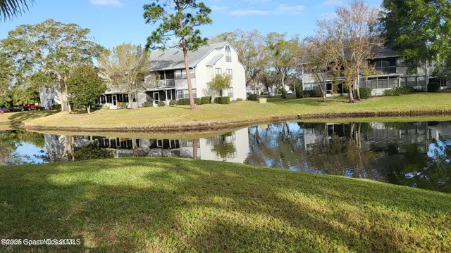 a view of swimming pool with outdoor seating and a garden