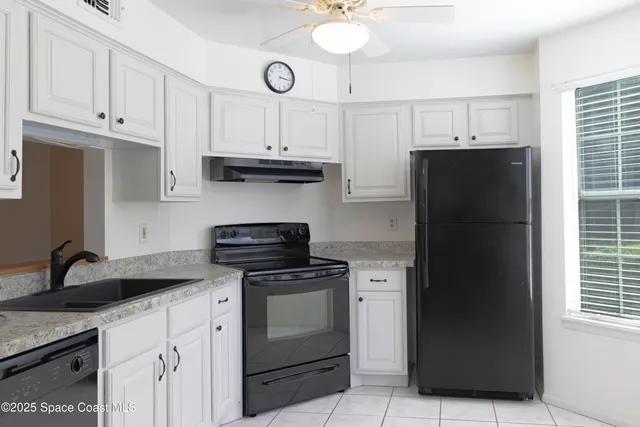 a kitchen with stainless steel appliances granite countertop a refrigerator sink and cabinets