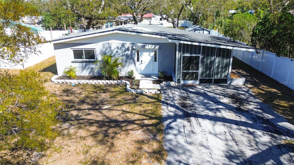 a view of house with yard and sitting area
