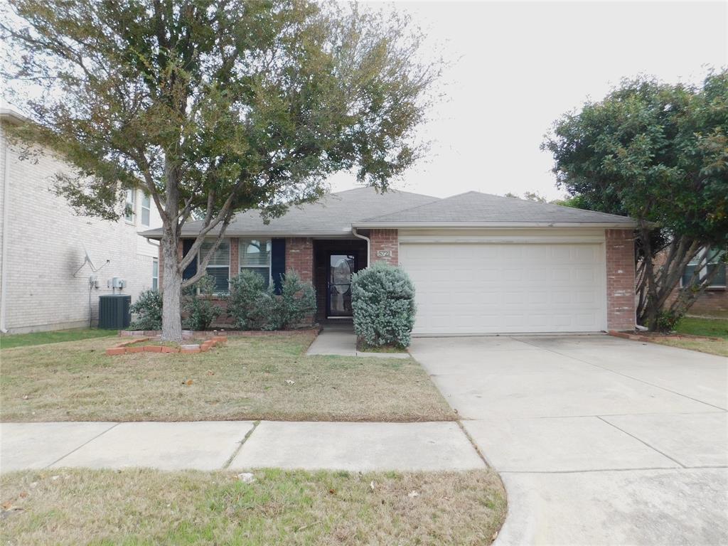 5721 Thoroughbred Trail Denton, TX 76210 - Photo 1 of 24 a front view of a house with a yard and garage