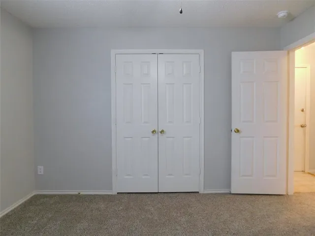 an empty room with closet area