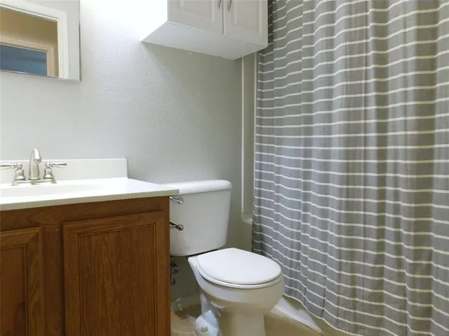a bathroom with a sink a toilet and a mirror