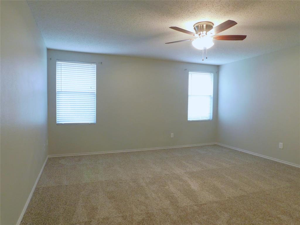 5721 Thoroughbred Trail Denton, TX 76210 - Photo 15 of 24 an empty room with a window and a fan