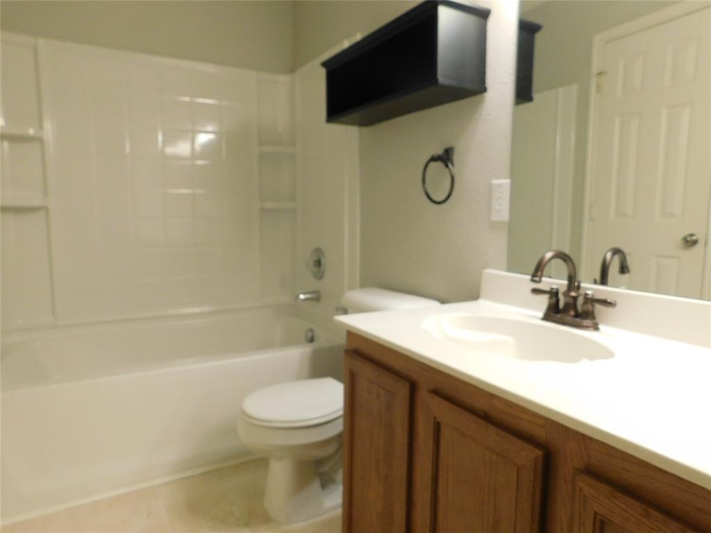 5721 Thoroughbred Trail Denton, TX 76210 - Photo 16 of 24 a bathroom with a sink a toilet and shower