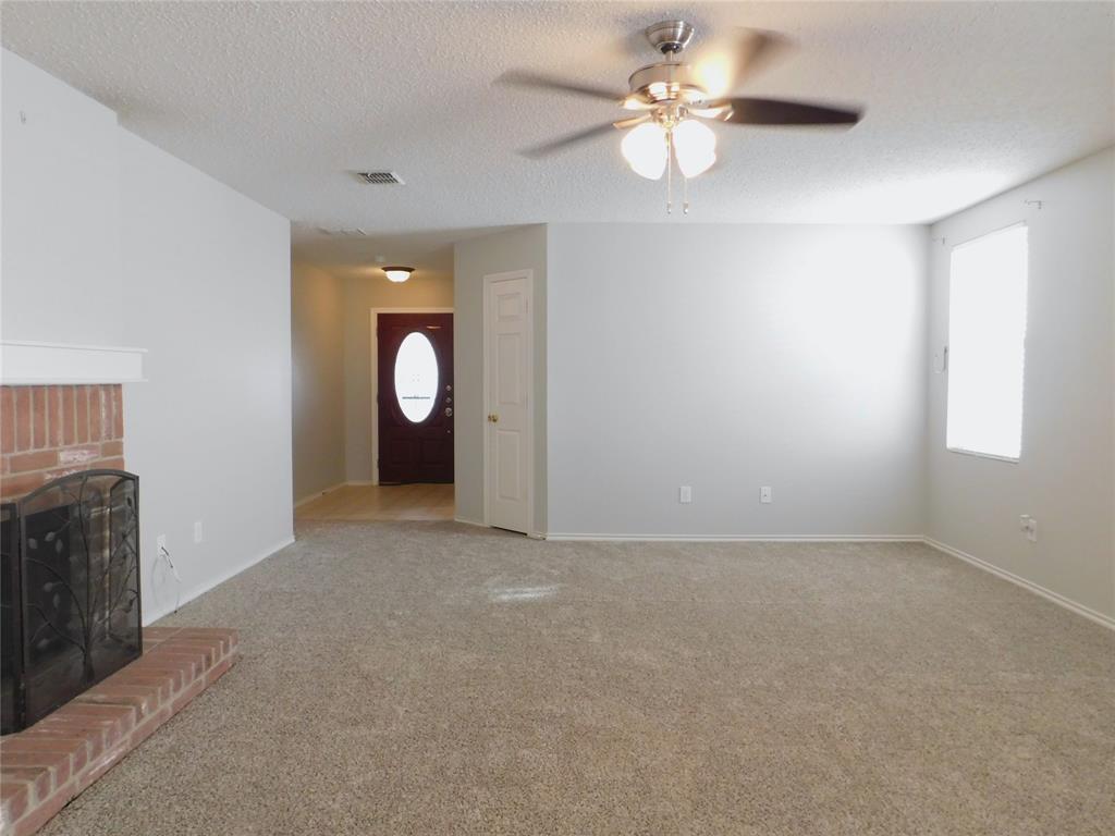 5721 Thoroughbred Trail Denton, TX 76210 - Photo 3 of 24 wooden floor in an empty room with a window