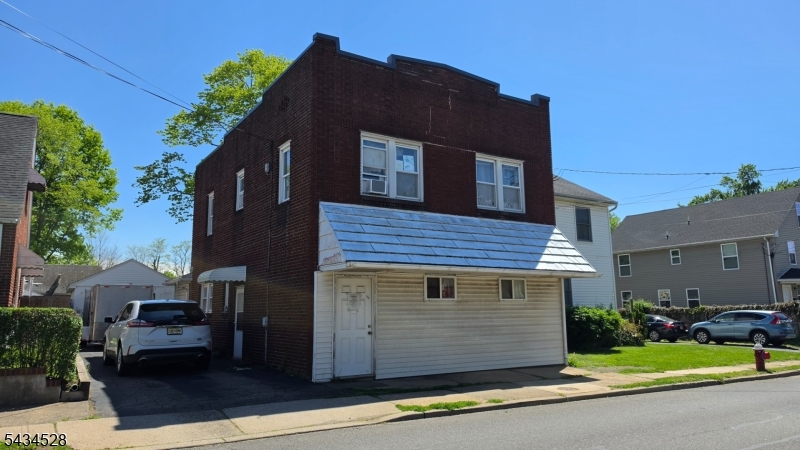 1115 West Camplain Road Manville, NJ 08835 - Photo 2 of 18 a view of a brick house with many windows next to a road