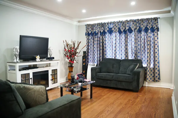 a living room with furniture a flat screen tv and a fireplace