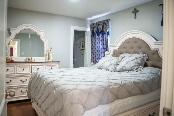 a bedroom with a bed and a mirror