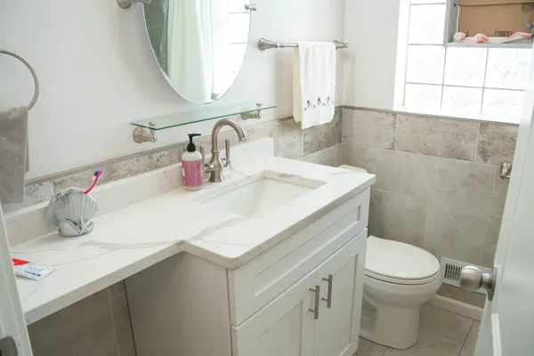 a bathroom with a sink toilet and mirror
