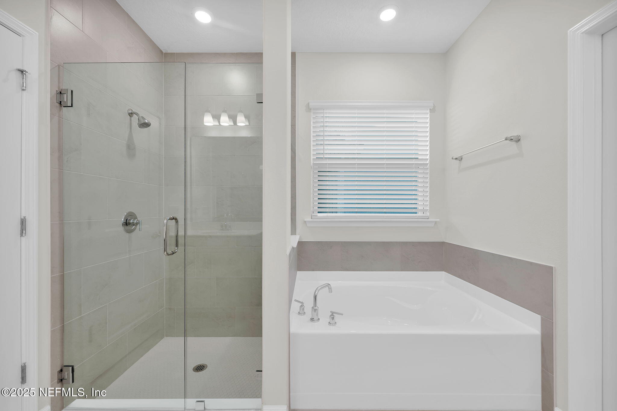 87 Whirlwind Place St. Augustine, FL 32095 - Photo 11 of 44 a bathroom with a bathtub a shower and a window