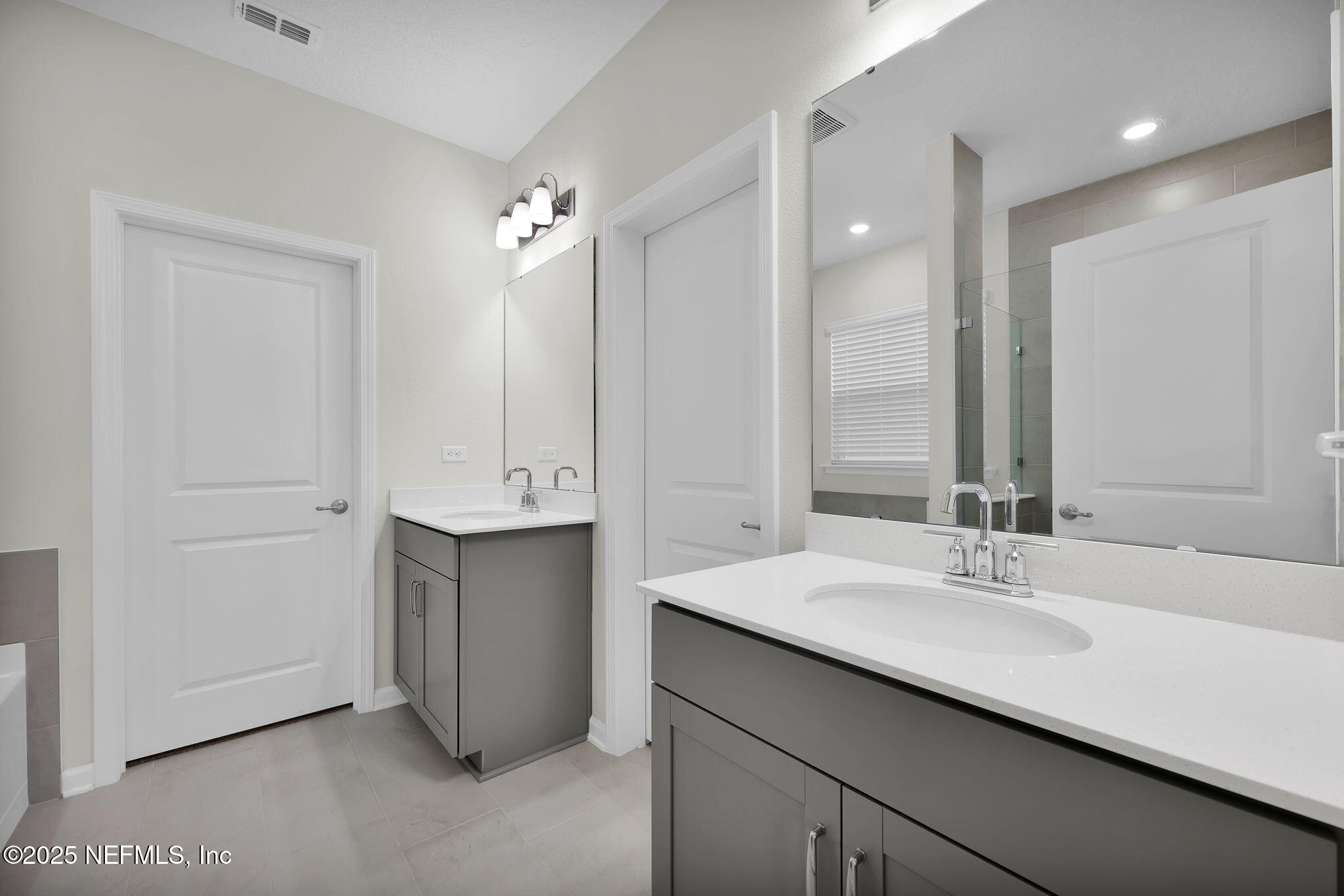 87 Whirlwind Place St. Augustine, FL 32095 - Photo 12 of 44 a bathroom with a double vanity sink and a mirror