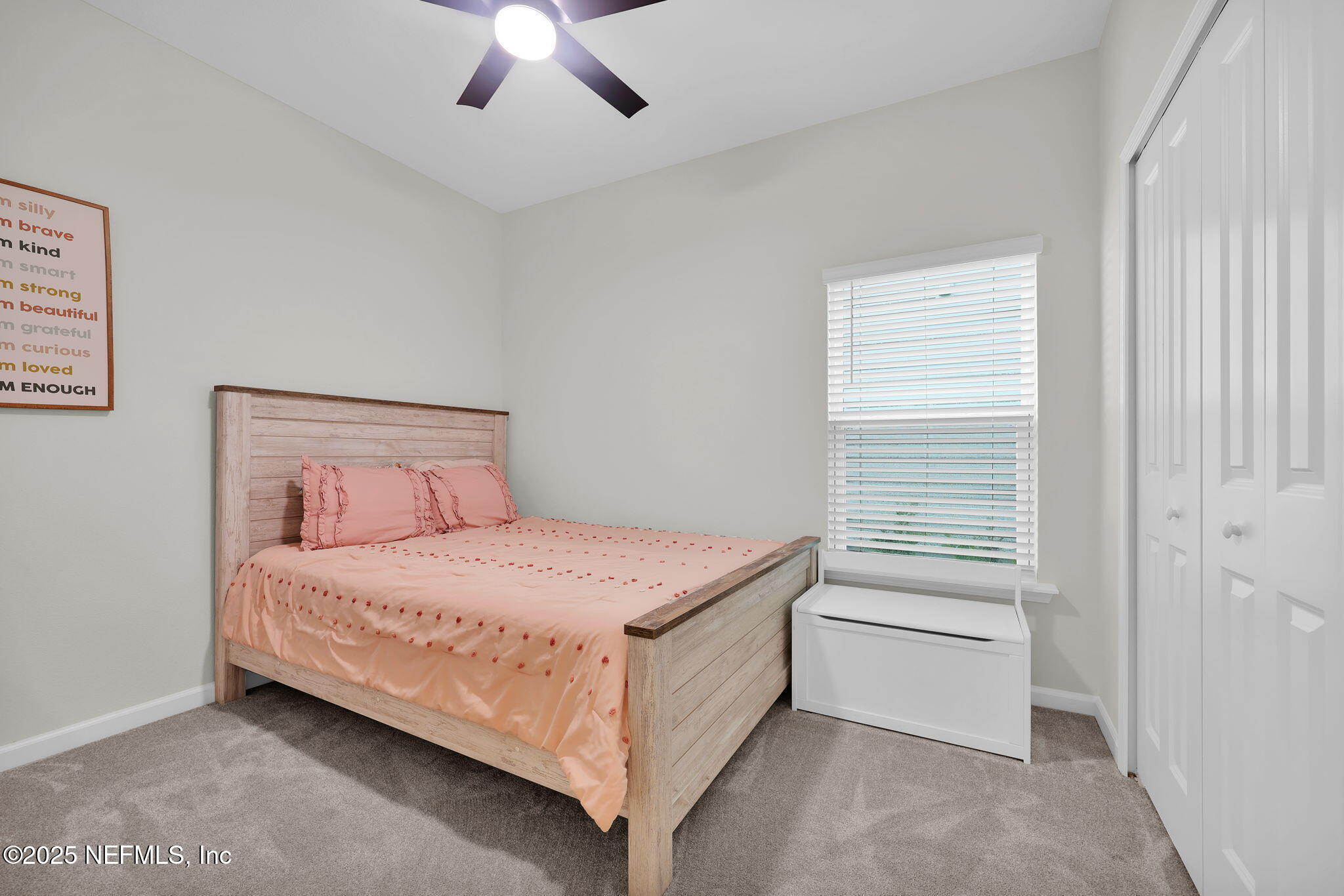 87 Whirlwind Place St. Augustine, FL 32095 - Photo 16 of 44 a bedroom with a bed and a chandelier fan