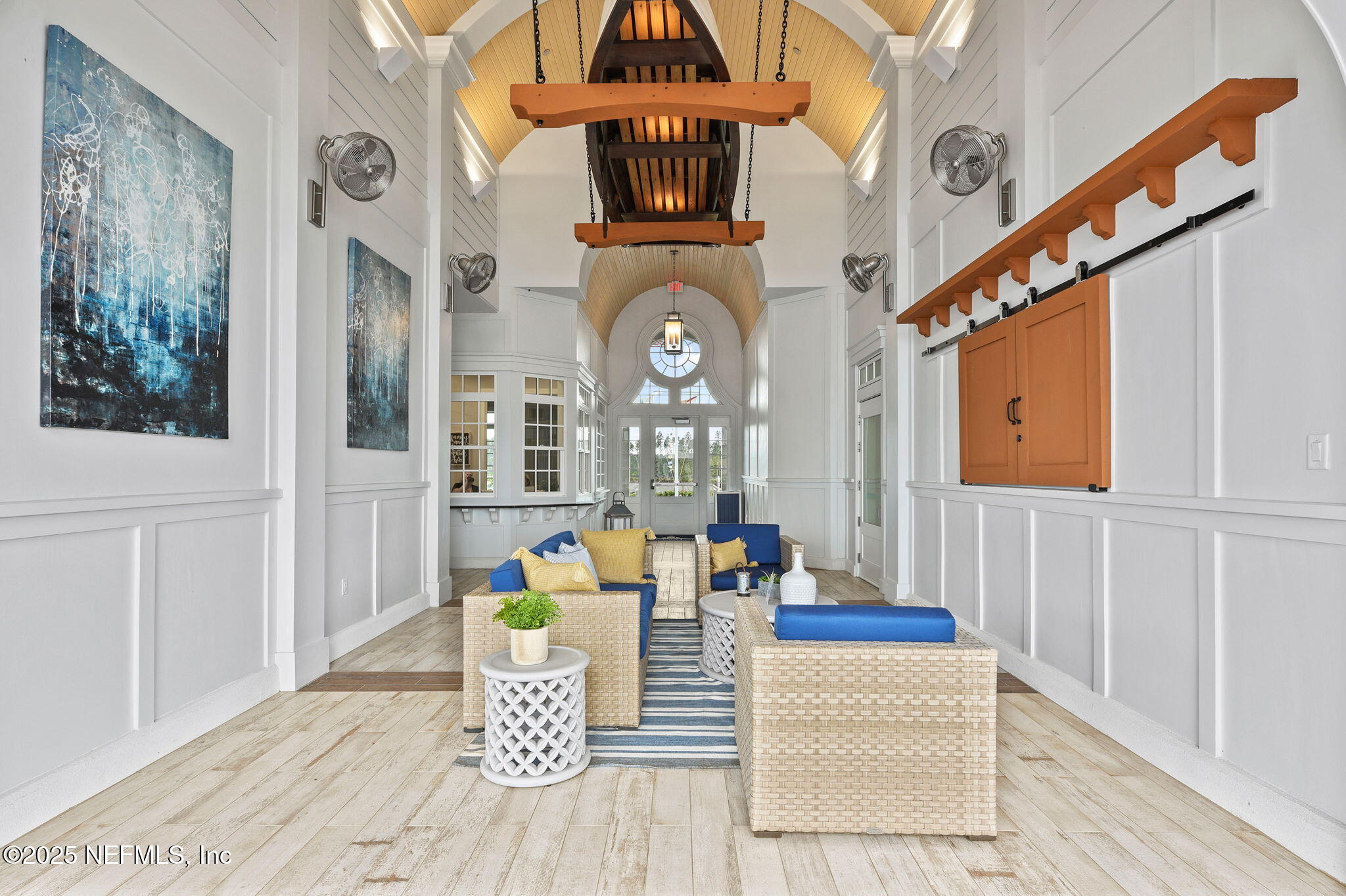 87 Whirlwind Place St. Augustine, FL 32095 - Photo 35 of 44 a view of a hallway with dining area and chandelier
