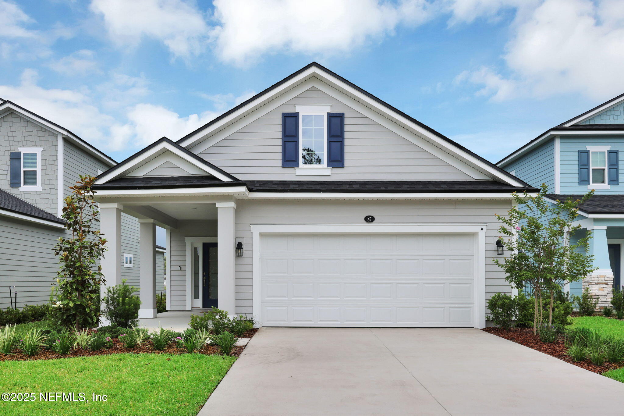 87 Whirlwind Place St. Augustine, FL 32095 - Photo 5 of 44 a front view of a house with a yard and garage