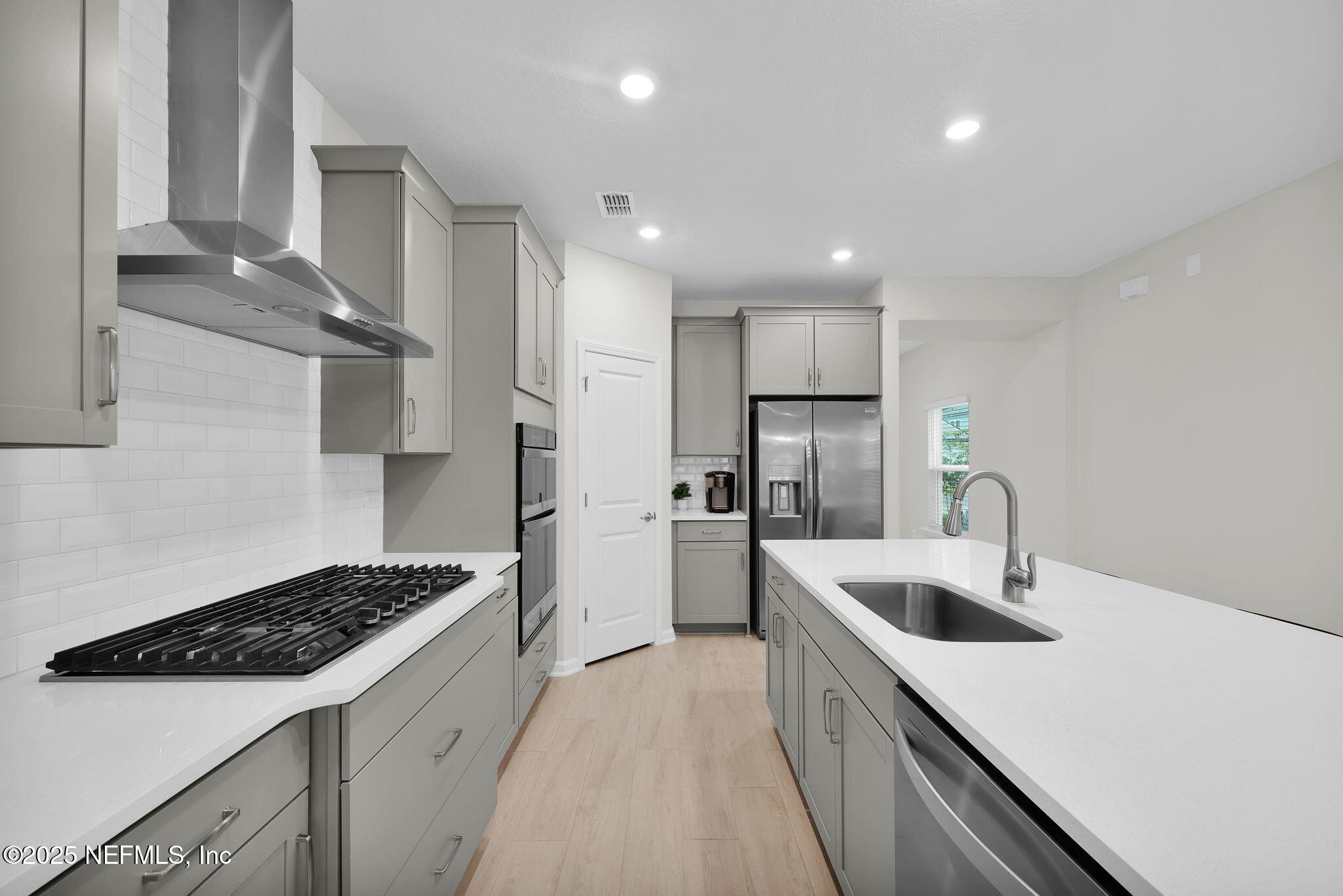 87 Whirlwind Place St. Augustine, FL 32095 - Photo 6 of 44 a kitchen with refrigerator and stove