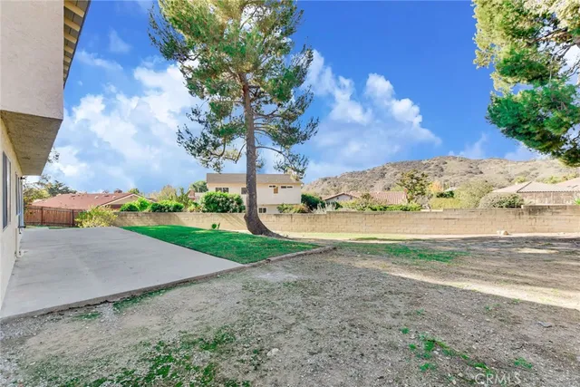a view of a yard with large trees