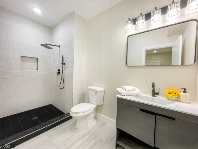 a bathroom with a sink a toilet and mirror