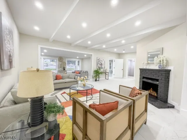 a living room with furniture a fireplace and a table