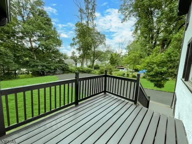 a view of balcony with wooden floor and fence