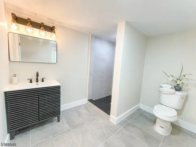 a bathroom with a sink toilet and mirror