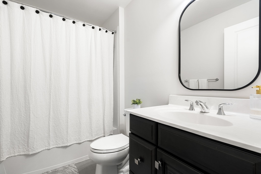 2 Hummingbird Way, Unit 1 Methuen, MA 01844 - Photo 28 of 42 a bathroom with a sink vanity mirror and toilet