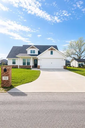 a view of house with yard in front of it