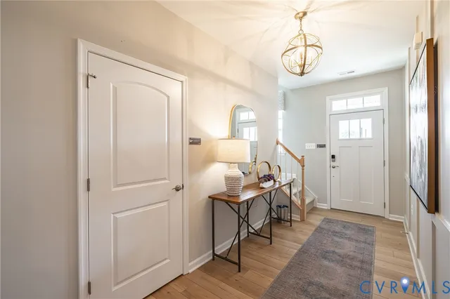 a view of a livingroom with furniture wooden floor and a chandelier