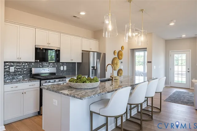 a kitchen with sink a microwave and cabinets