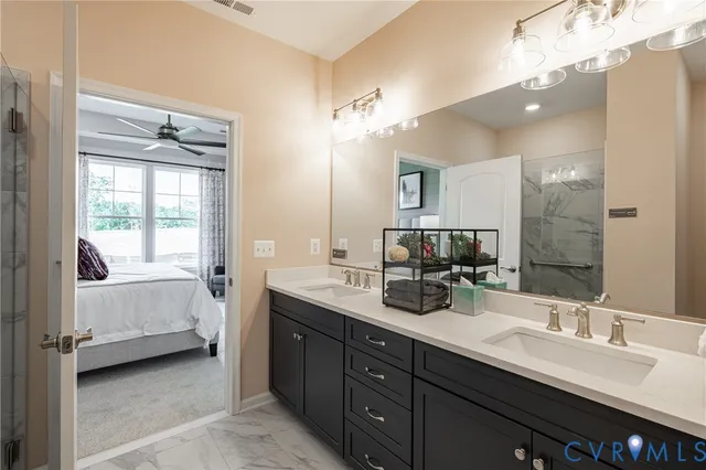 a en suite bathroom with double vanity and a mirror