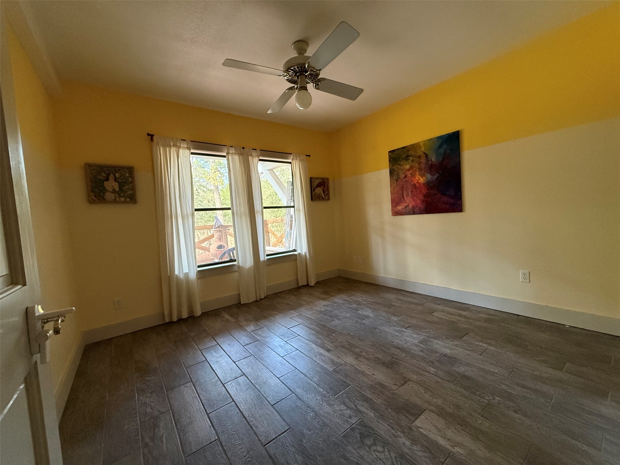 363 Porter Road Bastrop, TX 78602 - Photo 27 of 37 A versatile room features durable wood-look tile flooring and multiple windows letting in natural light.