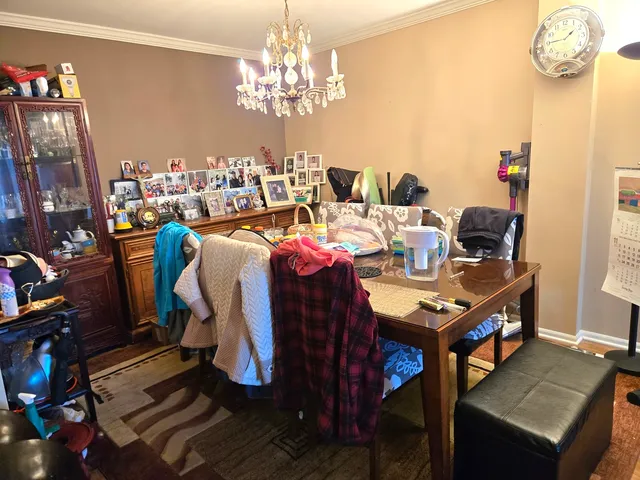 a view of a dining room with furniture and chandelier