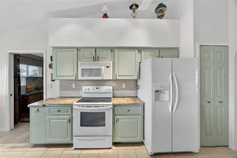 a kitchen with a stove cabinets and refrigerator