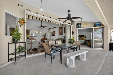 a view of a livingroom with furniture and a ceiling fan
