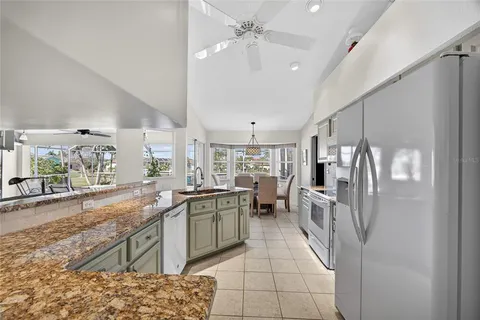 a kitchen with a sink a counter top space stainless steel appliances and a large window