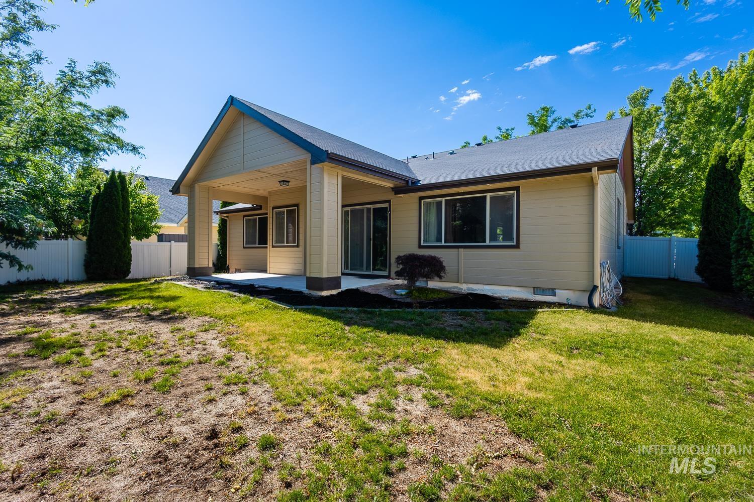 1186 East Observation Street Meridian, ID 83642 - Photo 32 of 33 Rear exterior featuring a covered patio, tan siding, and a dark shingle roof