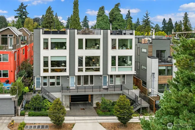 a front view of a residential apartment building with a yard