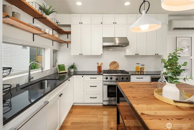 a large white kitchen with lots of counter space and a sink