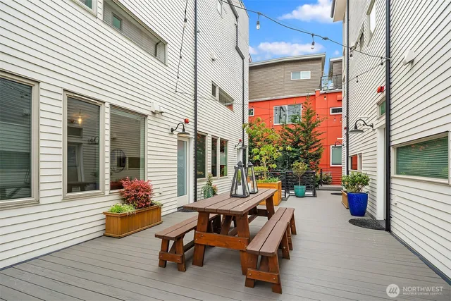 a view of a chairs and table in the back yard of the house