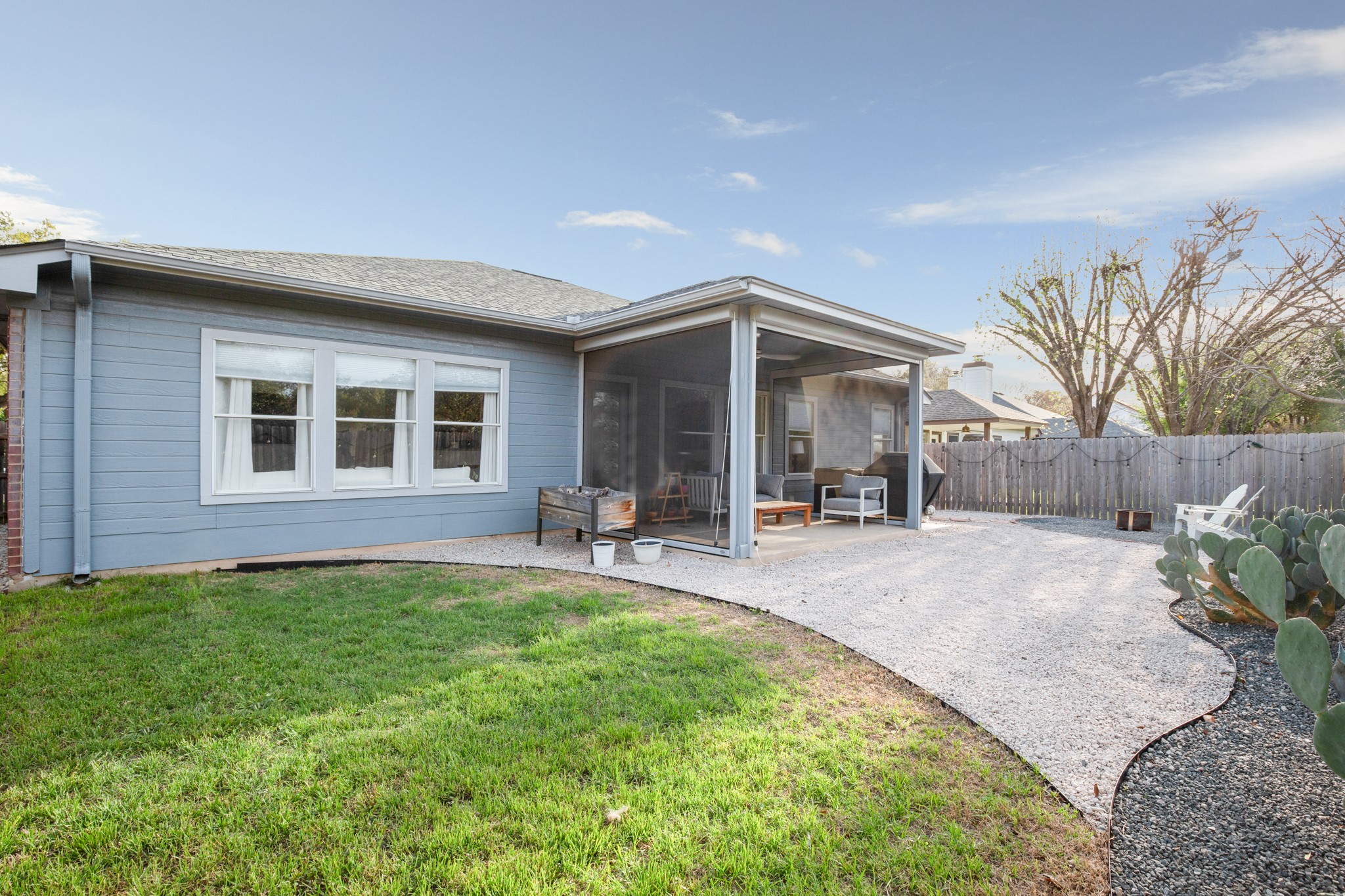4523 Ramies Run Austin, TX 78749 - Photo 14 of 30 Back of property featuring a sunroom, a fenced backyard, roof with shingles, and a patio area